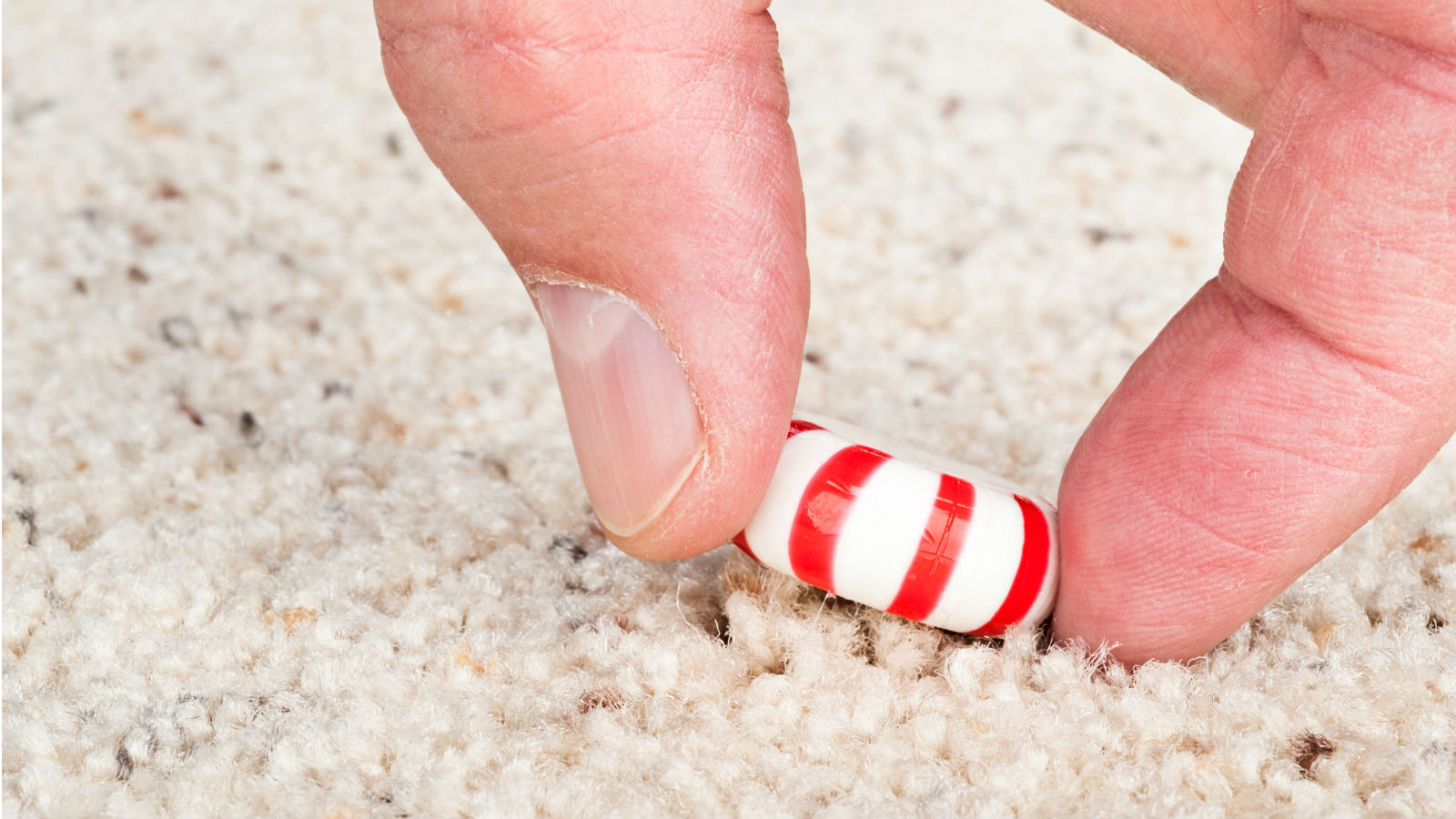 hand picking up candy from floor