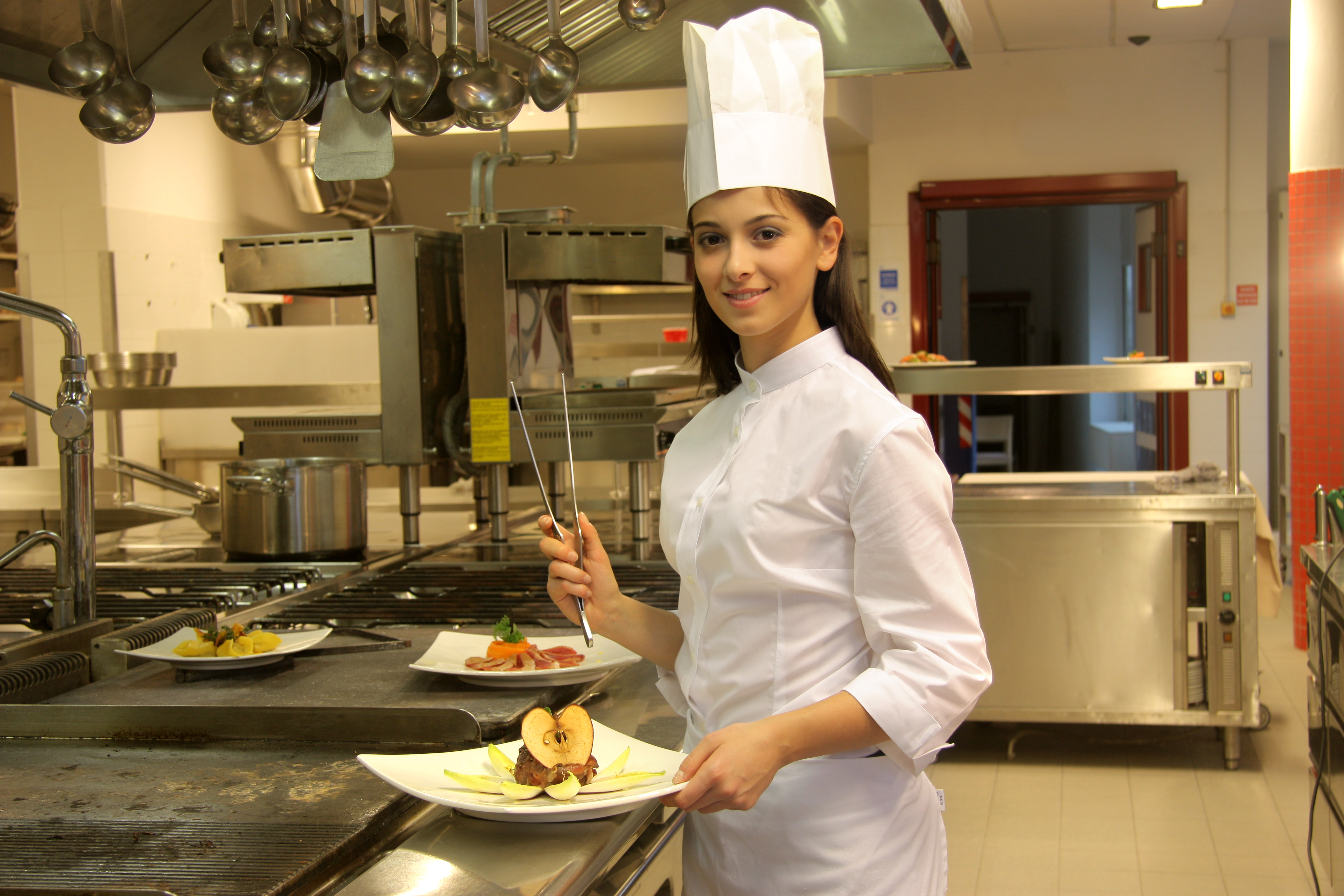 young female chef preparing food in a restaurant