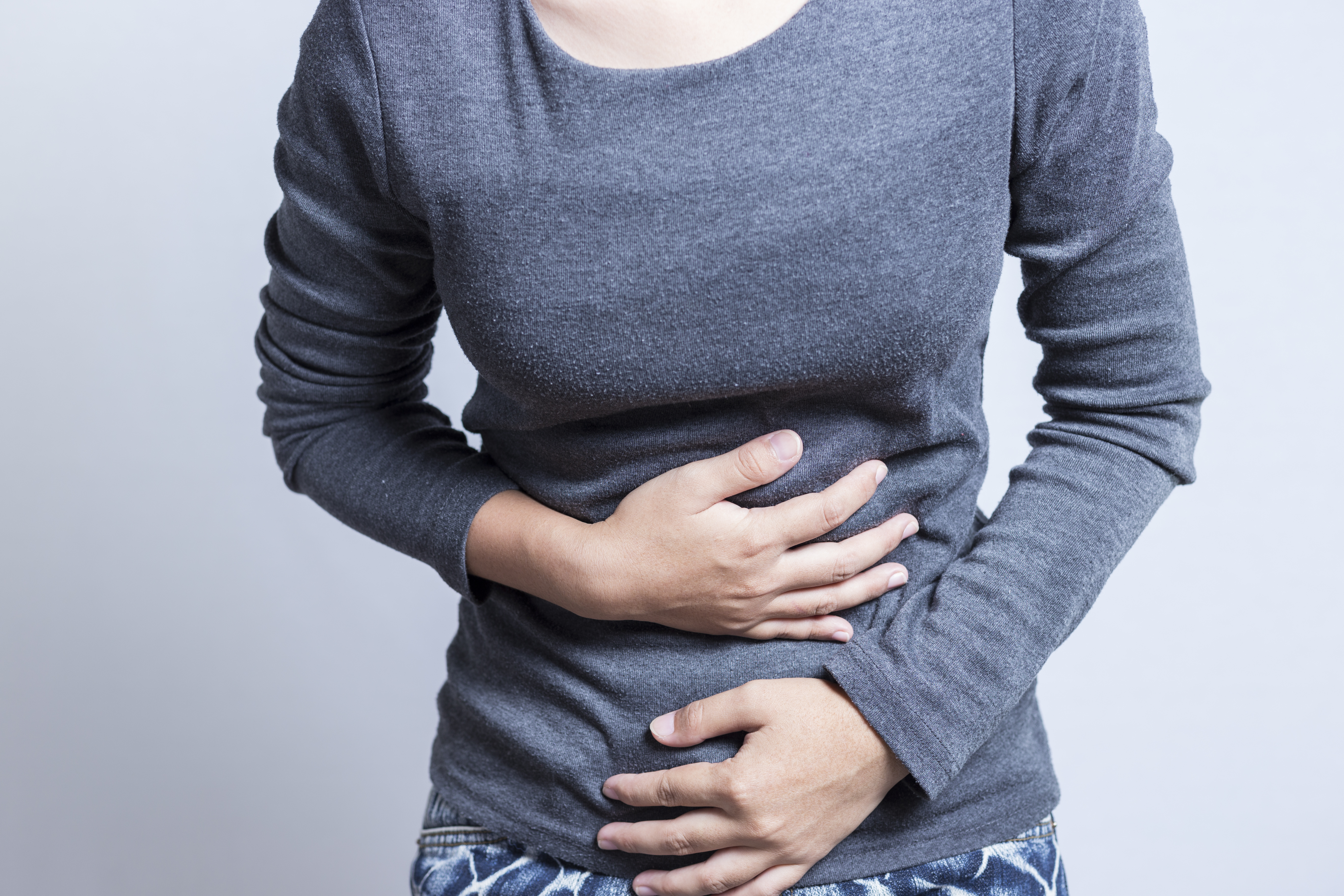 sick person clutching abdomen
