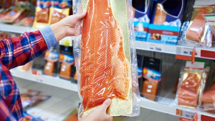 Man holding packaged fish