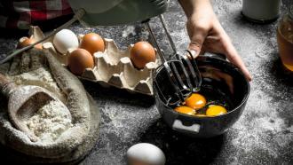 Food handler cooking eggs