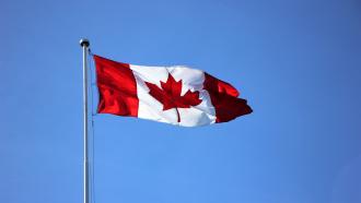 Canadian flag against blue sky