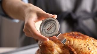 Meat thermometer to check if chicken is cooked