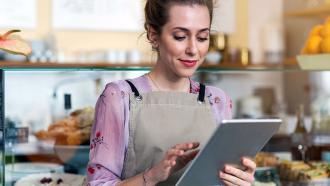 Cafe worker looking at tablet