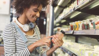 Woman examining nutrition label on food package