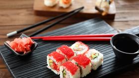 Sushi on a plate with chopsticks